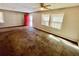 Shows a spacious living room with windows, a red front door and a ceiling fan at 1292 Lorenzo Sw Dr, Atlanta, GA 30310