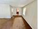Empty living room with gray walls and visible floors with a window for natural light at 1292 Lorenzo Sw Dr, Atlanta, GA 30310