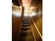 Stairway with carpet treads and wood paneling leads to the upper level of the home at 1292 Lorenzo Sw Dr, Atlanta, GA 30310
