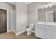 Bathroom with standing shower, toilet, sink with storage, and tiled floors at 1547 Cambridge Pl, Marietta, GA 30062