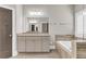Bright bathroom with granite countertop, wood tile floor, and neutral cabinets at 1547 Cambridge Pl, Marietta, GA 30062