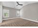Bedroom features vaulted ceiling, neutral carpet, two windows with plantation shutters, and ceiling fan at 1547 Cambridge Pl, Marietta, GA 30062
