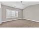Bright bedroom featuring shuttered windows, plush carpeting, and neutral walls at 1547 Cambridge Pl, Marietta, GA 30062