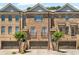 Brick townhome featuring a two-car garage and manicured landscaping at 1547 Cambridge Pl, Marietta, GA 30062