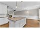 Island in a modern kitchen offering granite countertops, stylish pendant lighting, and seating space at 1547 Cambridge Pl, Marietta, GA 30062
