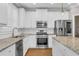 Modern kitchen with stainless steel appliances, granite countertops, a center island, and white cabinetry at 1547 Cambridge Pl, Marietta, GA 30062