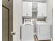 Laundry room with overhead storage and side-by-side washer and dryer at 1547 Cambridge Pl, Marietta, GA 30062