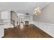 Open living room with hardwood floors, a fireplace, and seamless kitchen access and abundant natural light at 1547 Cambridge Pl, Marietta, GA 30062
