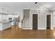 Well-lit living room with hardwood floors, adjacent to a modern kitchen, and includes a staircase at 1547 Cambridge Pl, Marietta, GA 30062