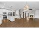 Spacious living area with seamless kitchen access, hardwood floors, and a cozy fireplace at 1547 Cambridge Pl, Marietta, GA 30062