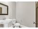 A bright and modern powder room features a pedestal sink and updated fixtures at 1547 Cambridge Pl, Marietta, GA 30062