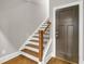 Staircase with wood treads and decorative iron spindles leads to the upper level at 1547 Cambridge Pl, Marietta, GA 30062
