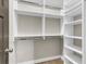 Walk-in closet with custom shelves and hanging rods, maximizing storage space at 1547 Cambridge Pl, Marietta, GA 30062