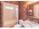Cozy bathroom with patterned wallpaper, a toilet, and shower-tub combination at 1900 Briergate Dr, Duluth, GA 30097