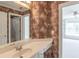 Bathroom featuring a white vanity, sink and neutral wallpaper with a view of the next room at 1900 Briergate Dr, Duluth, GA 30097