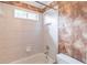 Bathroom with a shower and tub combo, neutral colored tile, and unique brown wallpaper at 1900 Briergate Dr, Duluth, GA 30097