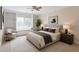 Inviting bedroom with a window seat, built-in shelves, ceiling fan, and neutral tones at 1900 Briergate Dr, Duluth, GA 30097