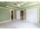 Green bedroom offering trey ceilings, ensuite bathroom and staircase access at 1900 Briergate Dr, Duluth, GA 30097