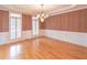 Formal dining room with hardwood floors, wainscoting, and a chandelier at 1900 Briergate Dr, Duluth, GA 30097