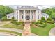 Stately home featuring manicured landscaping, columns and a covered front porch at 1900 Briergate Dr, Duluth, GA 30097
