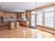 Bright kitchen with wooden cabinets, an island with granite countertop, and hardwood floors at 1900 Briergate Dr, Duluth, GA 30097