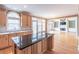Open-concept kitchen with a center island, hardwood floors, and adjacent living space at 1900 Briergate Dr, Duluth, GA 30097
