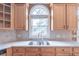 Kitchen with stainless steel sink, tile backsplash, natural wood cabinets, and hardwood floors at 1900 Briergate Dr, Duluth, GA 30097
