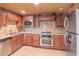 Basement kitchenette featuring wood cabinetry, stainless appliances, and neutral countertops at 1900 Briergate Dr, Duluth, GA 30097