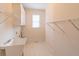 Bright laundry room with ample storage and a utility sink at 1900 Briergate Dr, Duluth, GA 30097