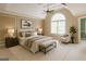 Staged main bedroom with a large bed, seating, and paneled walls at 1900 Briergate Dr, Duluth, GA 30097