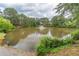 Community pond with fountain feature and lush green surroundings at 1900 Briergate Dr, Duluth, GA 30097