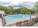 Community pool featuring a water slide, seating, and clear blue water for a refreshing swimming experience at 1900 Briergate Dr, Duluth, GA 30097