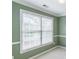 Window with blinds and green walls add a pop of color at 1900 Briergate Dr, Duluth, GA 30097
