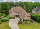 Spacious home with manicured lawn, mature trees, and a long circular driveway at 280 Selkirk Ln, Johns Creek, GA 30097