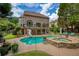 Resort-style backyard with private pool, hot tub, water slide, and large patio area at 280 Selkirk Ln, Johns Creek, GA 30097