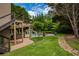 Scenic backyard featuring a pool with a slide and a cozy under deck seating area at 280 Selkirk Ln, Johns Creek, GA 30097