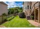 Landscaped backyard with a garden and direct access from deck with stairs at 280 Selkirk Ln, Johns Creek, GA 30097