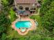 Aerial view of the backyard with a large in-ground pool, spa, and deck at 280 Selkirk Ln, Johns Creek, GA 30097