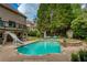 Expansive backyard featuring a pool, spa, and a charming outdoor sitting area at 280 Selkirk Ln, Johns Creek, GA 30097