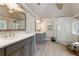 Bright bathroom with double sink vanity, tile floors, and a glass shower at 280 Selkirk Ln, Johns Creek, GA 30097