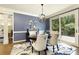 Dining room featuring blue walls, white trim, and large windows to the outside deck at 280 Selkirk Ln, Johns Creek, GA 30097
