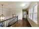 Bright hallway with hardwood floors, natural light from windows, and decorative chandelier fixture at 280 Selkirk Ln, Johns Creek, GA 30097
