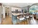 Open-concept kitchen with granite island, stainless steel appliances, and views into living area at 280 Selkirk Ln, Johns Creek, GA 30097