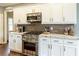 Modern kitchen with white cabinets, stainless steel appliances, and granite countertops at 280 Selkirk Ln, Johns Creek, GA 30097