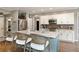 Kitchen features an island with bar seating, stainless steel appliances, and white cabinetry at 280 Selkirk Ln, Johns Creek, GA 30097