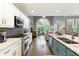 Spacious kitchen with stainless steel appliances, granite counters, and seamless flow to the living area at 280 Selkirk Ln, Johns Creek, GA 30097
