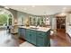 Bright kitchen featuring an island with granite countertops, stainless steel appliances, and an open dining area at 280 Selkirk Ln, Johns Creek, GA 30097
