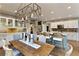 Open-concept kitchen and dining area with a large island and stylish lighting at 280 Selkirk Ln, Johns Creek, GA 30097