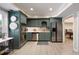 Stylish kitchenette with stainless steel appliances and unique green cabinets, ideal for modern living at 280 Selkirk Ln, Johns Creek, GA 30097