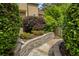 Beautiful landscaping and tiered stone walls with a stone paver walkway to the back yard at 280 Selkirk Ln, Johns Creek, GA 30097